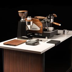 an espresso machine sitting on top of a counter next to a coffee maker