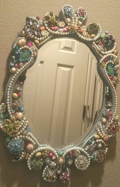 there is a mirror that has beads on it