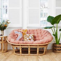 a living room filled with furniture and plants