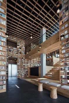 the interior of a library with wooden bookshelves and benches in front of them