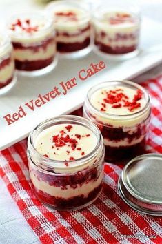 red velvet jar cake with white frosting and sprinkles in glass jars