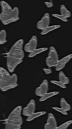 many clear butterflies are flying in the air with their wings spread out to form heart shapes