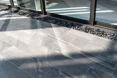 a skateboard is sitting on the ground in front of a building with glass doors