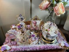 a table topped with lots of different types of jewelry and flowers on top of it