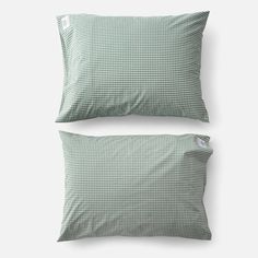 two pillows with green and white checkered pattern on the front, one is made out of