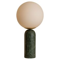 a green marble table lamp with a white ball on top