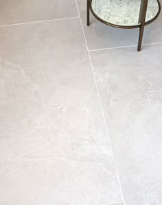 a bathroom with a glass table on the floor