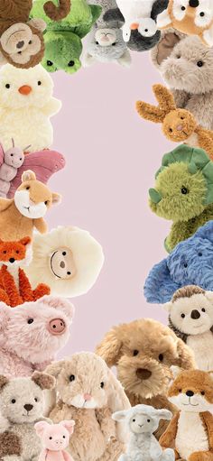 a group of stuffed animals are arranged in the shape of a circle on a pink background