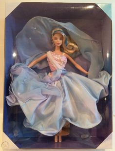 a barbie doll in a blue dress with blonde hair