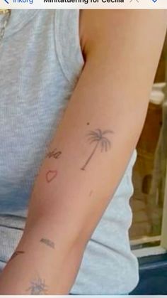 a person with a palm tree tattoo on their arm and the words i love you