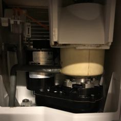 the inside of a refrigerator with water and food in it's bottom compartment,