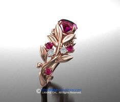 a rose shaped ring with pink stones and leaves