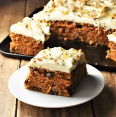 a piece of carrot cake sitting on top of a white plate next to a pan