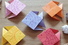 origami fish and sea shells on a table