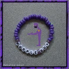 a purple beaded bracelet with words that spell out the word's name and a figure