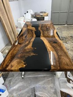 a table that has some kind of black and brown design on it, sitting in the middle of a room