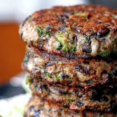 there are three patties stacked on top of each other, with broccoli in the middle