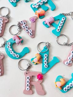 the letters are made out of clay and have different designs on each keychain