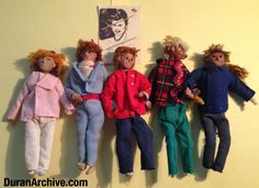 five dolls are lined up on the wall