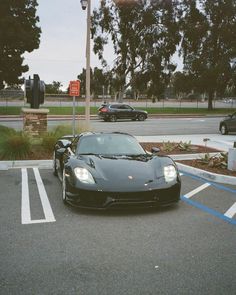 a black sports car parked in a parking lot