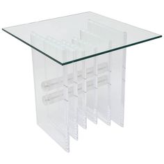 three clear acrylic tables stacked on top of each other, one with four tubes attached to it