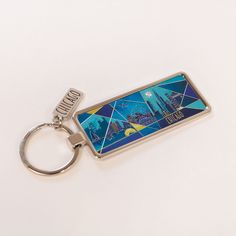 a metal keychain with an image of the wizard's castle on it