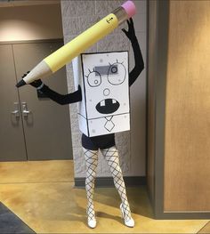 a person dressed as a cartoon character holding a giant pencil