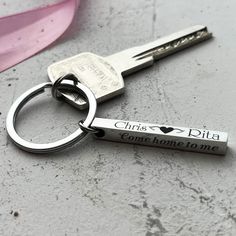 a couple of keys that are sitting next to each other on a table with pink ribbon