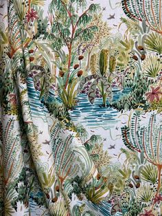 the fabric is very colorful and has many plants on it, including cacti