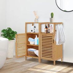 a bathroom with white walls and wooden furniture