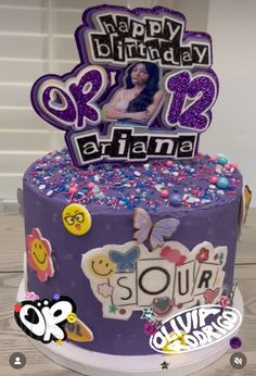 a purple birthday cake with an image of a woman on the top and words happy birthday ariana