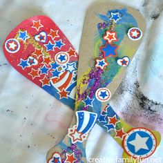 an art project made out of paper with scissors and stars painted on the blades in red, white, and blue