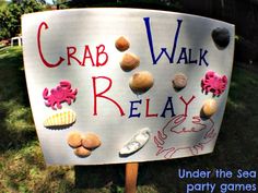 a sign that says crab walk relay under the sea party games on it's side