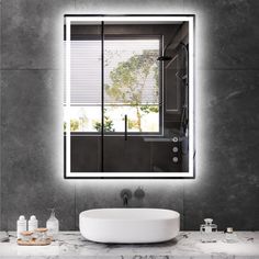 a bathroom sink sitting under a large mirror