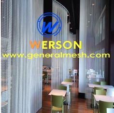 the interior of a restaurant with tables and chairs in front of a curtained wall