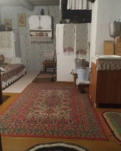 an old rug is on the floor in a small room