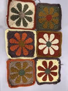 crocheted squares with flowers on them are arranged in the shape of squares