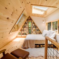 an attic bedroom with wooden walls and flooring