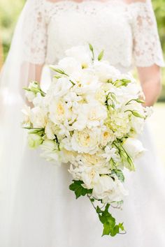 a bridal holding a bouquet of white flowers