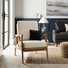 a living room filled with furniture and a painting on the wall