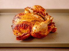 a roasted chicken on a baking sheet ready to be cooked