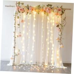 a white curtain with flowers and lights on it