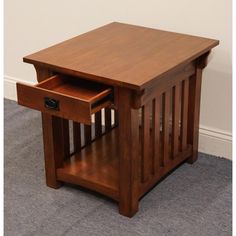 a wooden table with two drawers on top and carpeted flooring in front of it