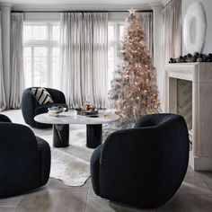 a living room filled with furniture and a christmas tree in the middle of the room