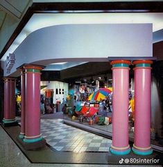 the inside of a store with pink pillars and checkered floor