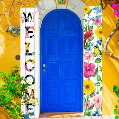 a bright blue door with flowers painted on it