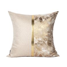 a gold and white pillow with two contrasting stripes on the front, one in metallic foil