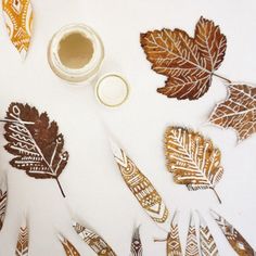 several different types of leaves and paint on a white surface with the words autumn written in it