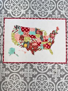 the united states quilted on top of a gray and white wallpaper with red trim