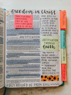 an open bible with colorful sticky notes attached to the pages that read, freedom in christ